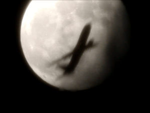 plane with moon backdrop